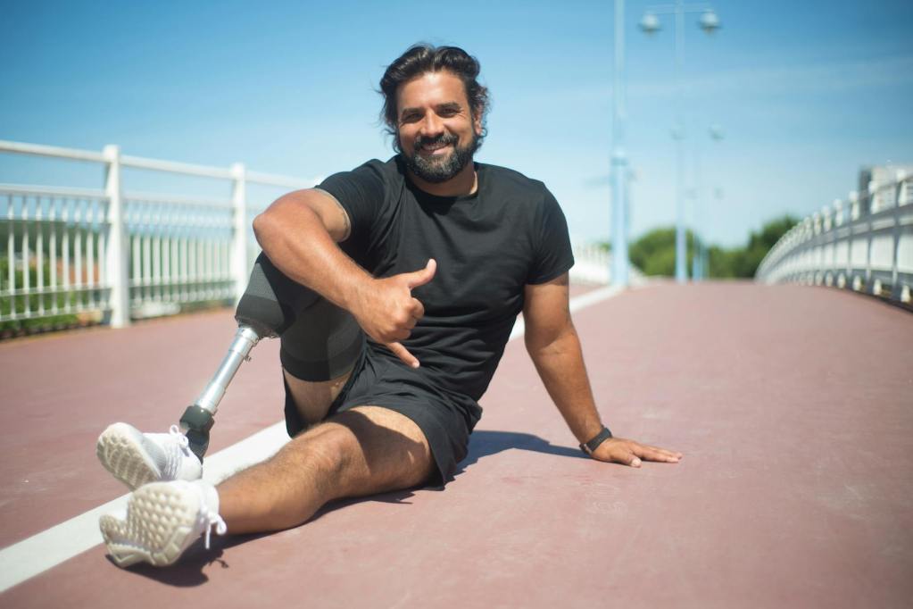 man in black crew neck t shirt and black shorts sitting on concrete floor